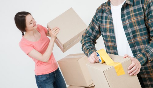 Careful loading of household items into a removal van for a Highbury flat move