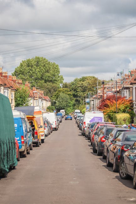 A street scene in Highbury during daytime shows a white and grey van belonging to Self Storage Highbury parked adjacent to a row of historic multi-storey buildings featuring brick facades, arched and 